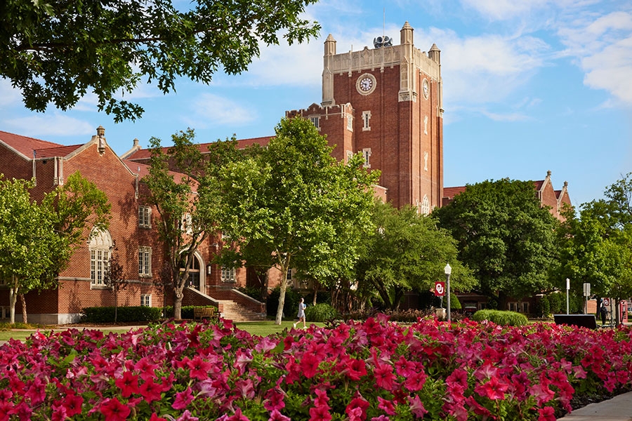The Oklahoma Memorial Union, with pink flowers in the foreground.