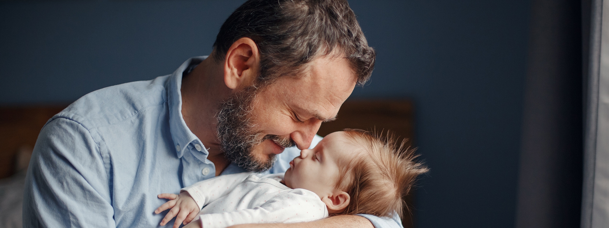 A father holding their newborn.
