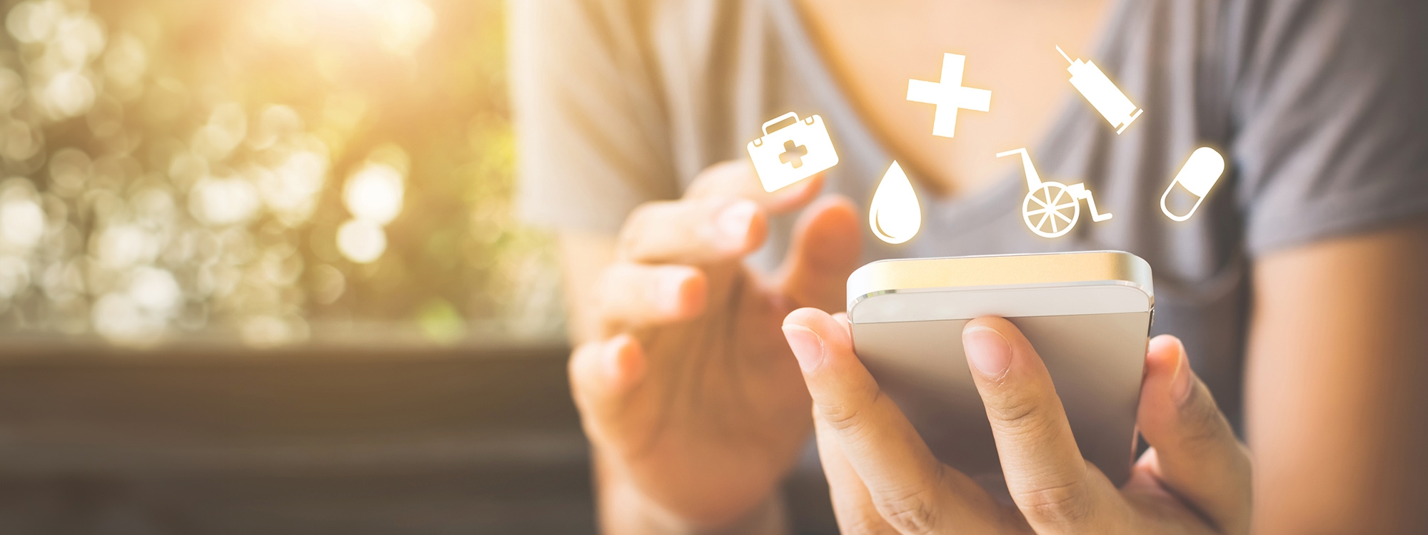 Woman holding a phone with glowing health icons around the screen.