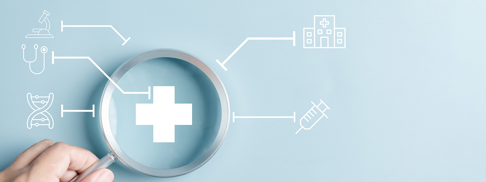 Magnifying glass with different medical icons overlayed.