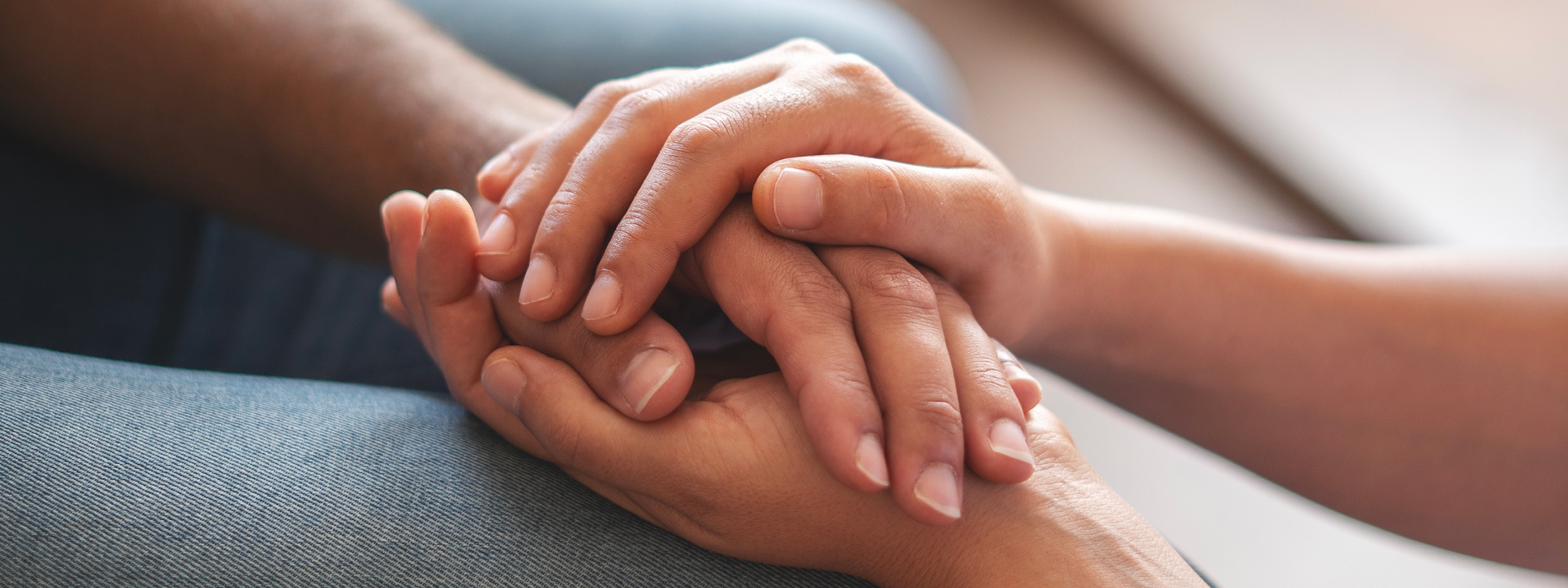 Interlocking hands reaching out.