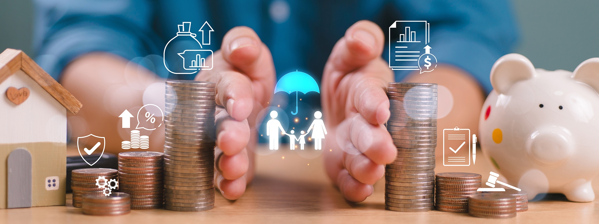 Hands splitting stacks of coins to two sides, with financial icons and a piggybank on the table.