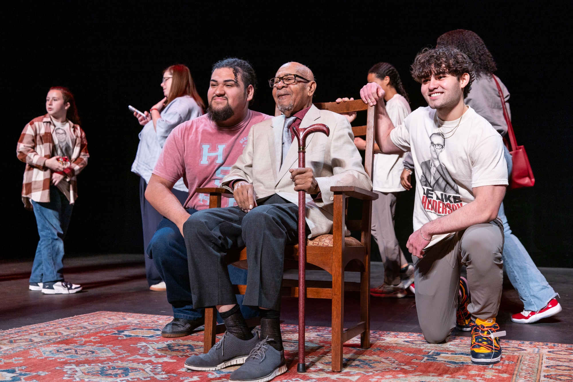 Dr. George Henderson at his Legacy Lecture on stage with a few Henderson Scholars.