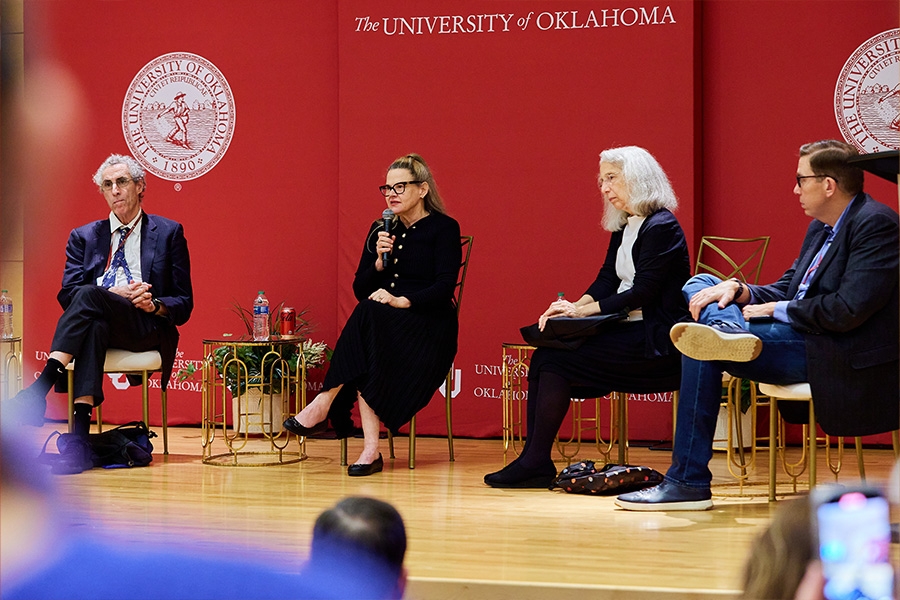 Four panelists on stage at a previous Teach-In event.