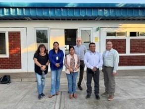 A group of researchers from LASI and UNSA pose in front of a building.