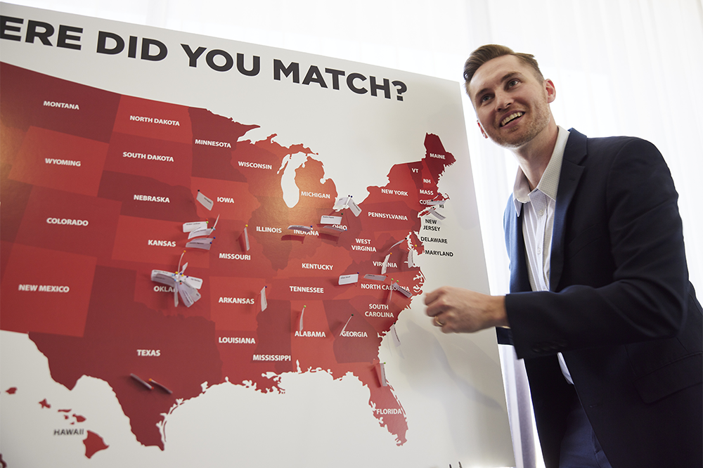 Moritz places a pin in a large map showing destinations of Matched students.