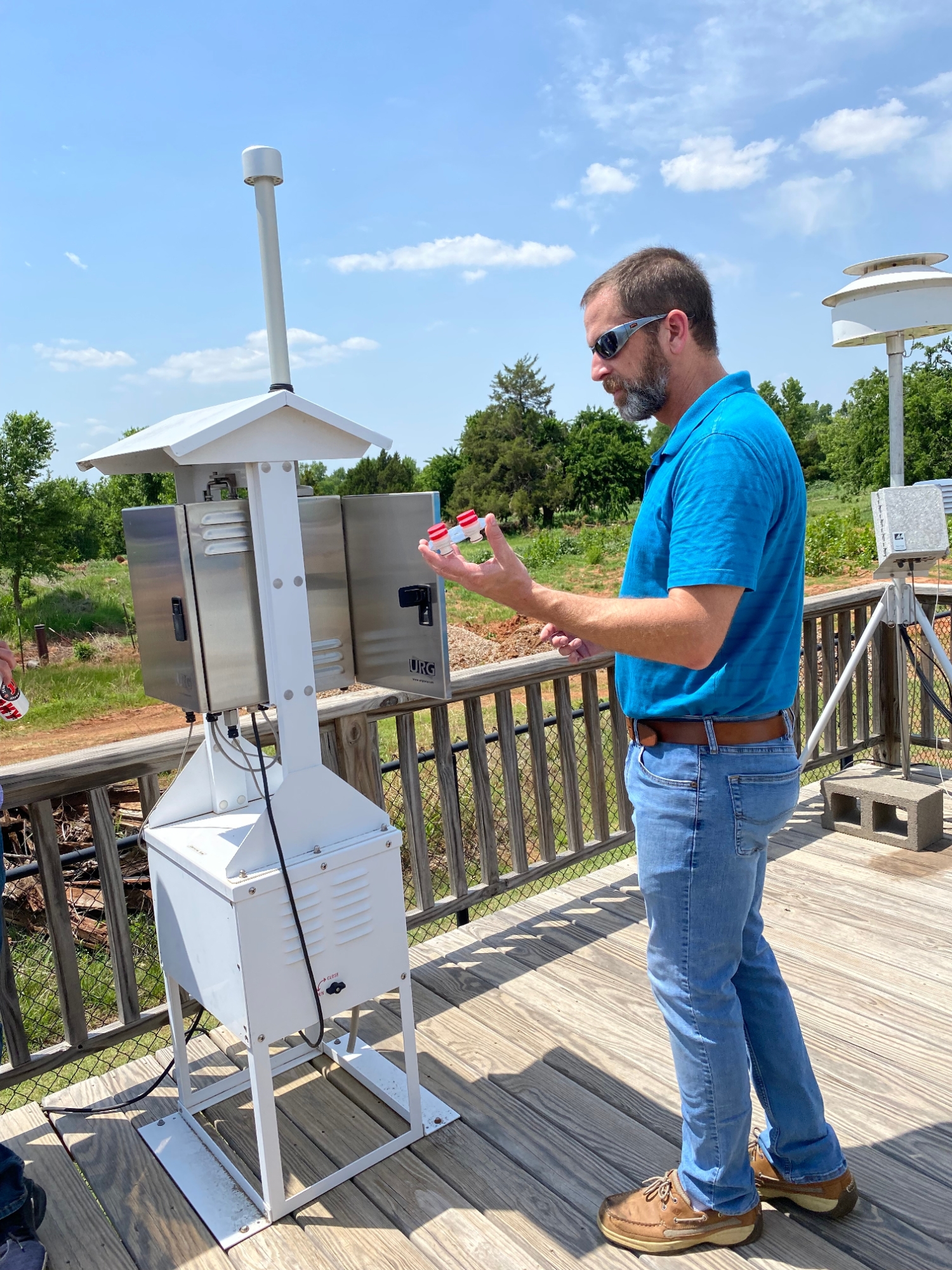  Oklahoma DEQ air quality scientist, Braxton Edwards, demonstrates a particulate matter sampling system used to isolate atmospheric organic-based particles.