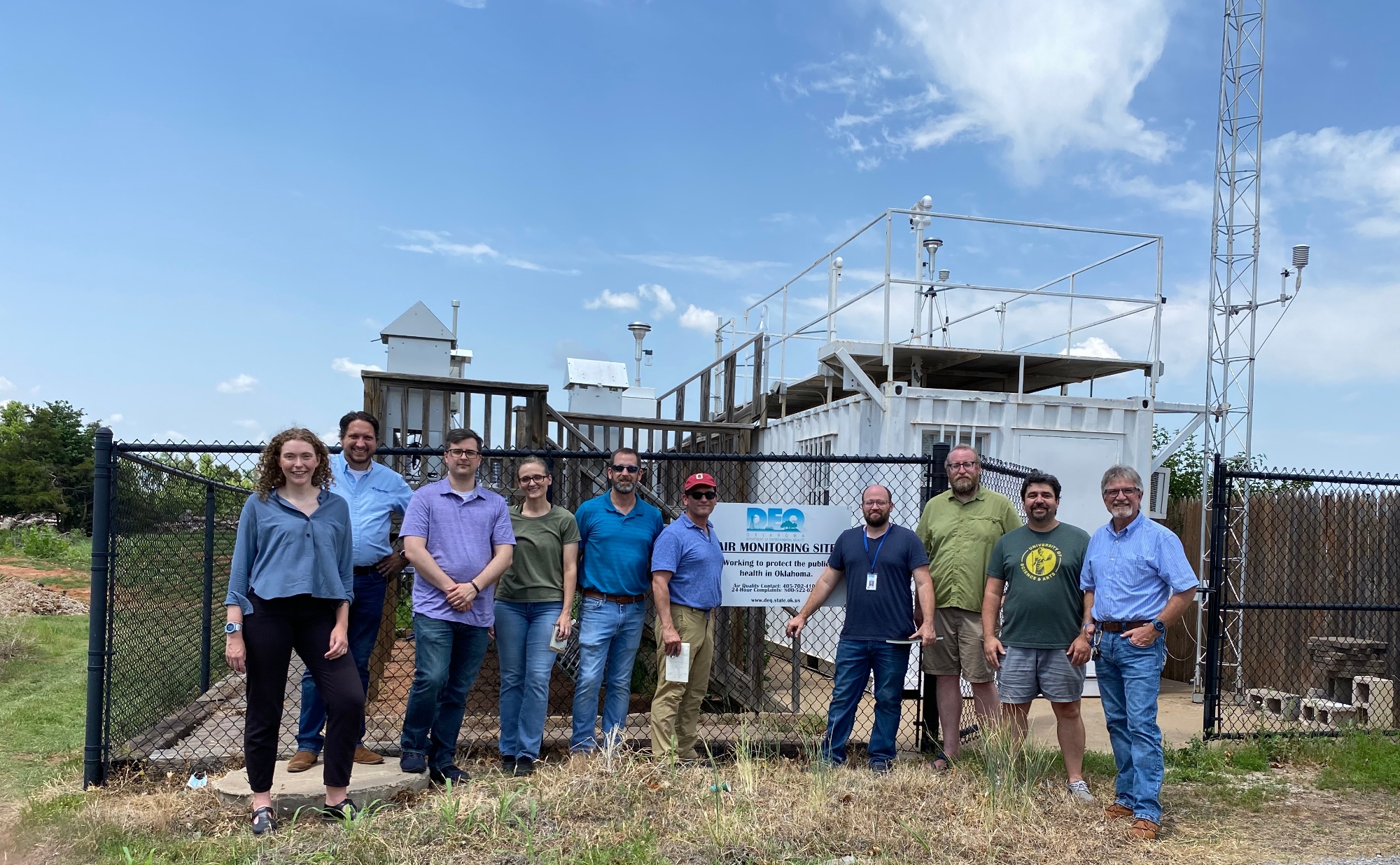 Ou Researchers stand in front of air quailty measuring machinery 