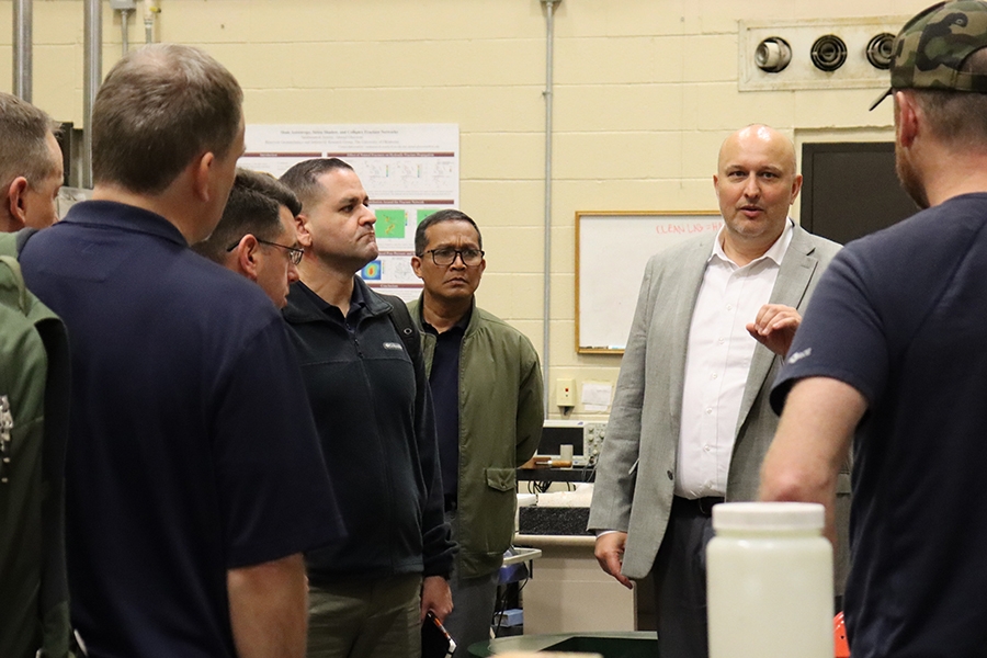 Rynar Nygaard, Ph.D., answers questions from NDU students during a lab tour.