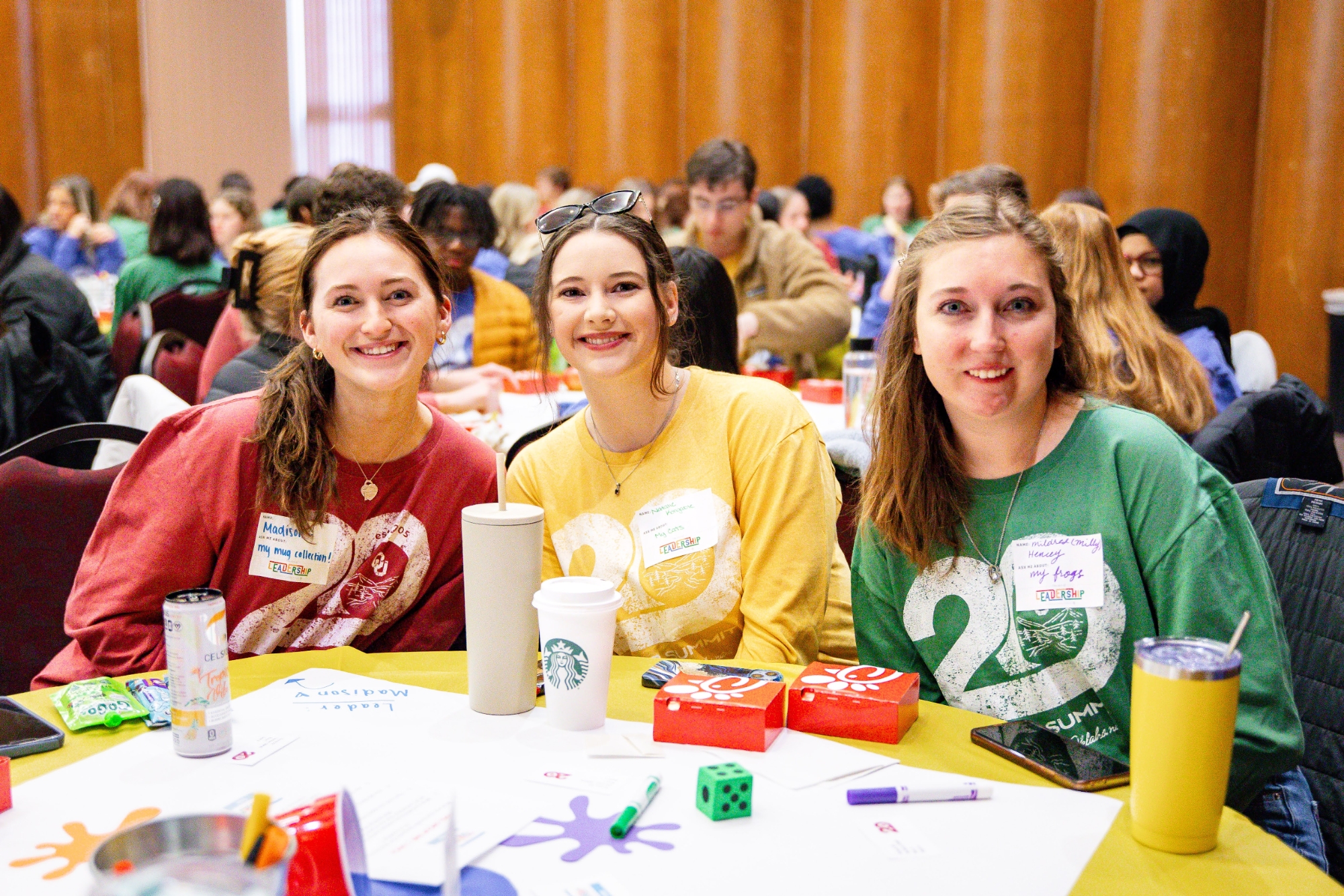 A photo of students sitting at a table at the 2025 Leader Summit.