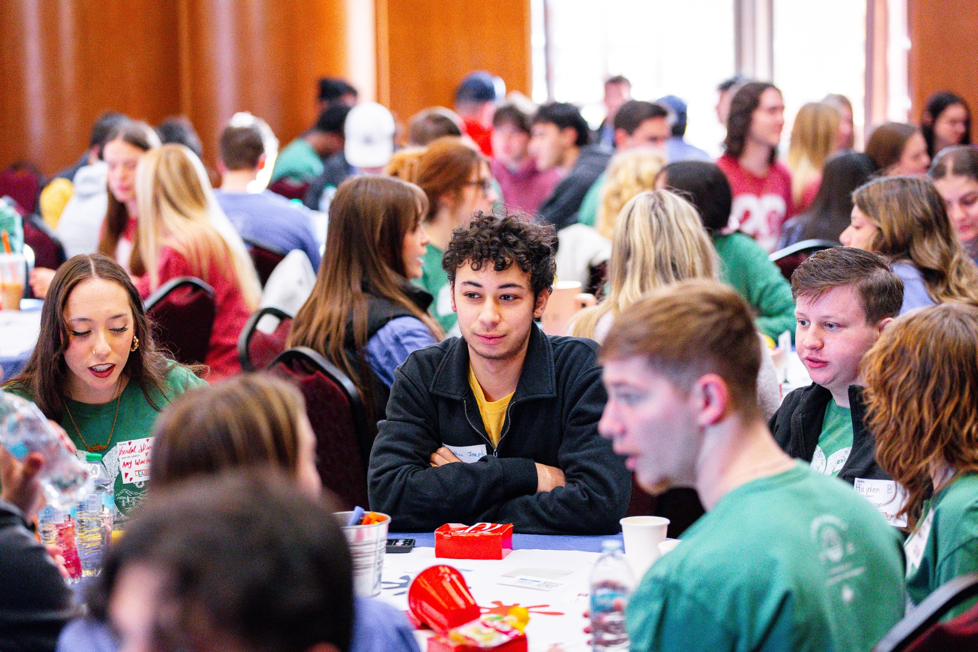 Students sitting around a table at the 2025 Leader Summit.