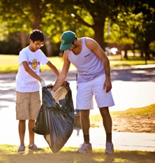 two male students picking up trash
