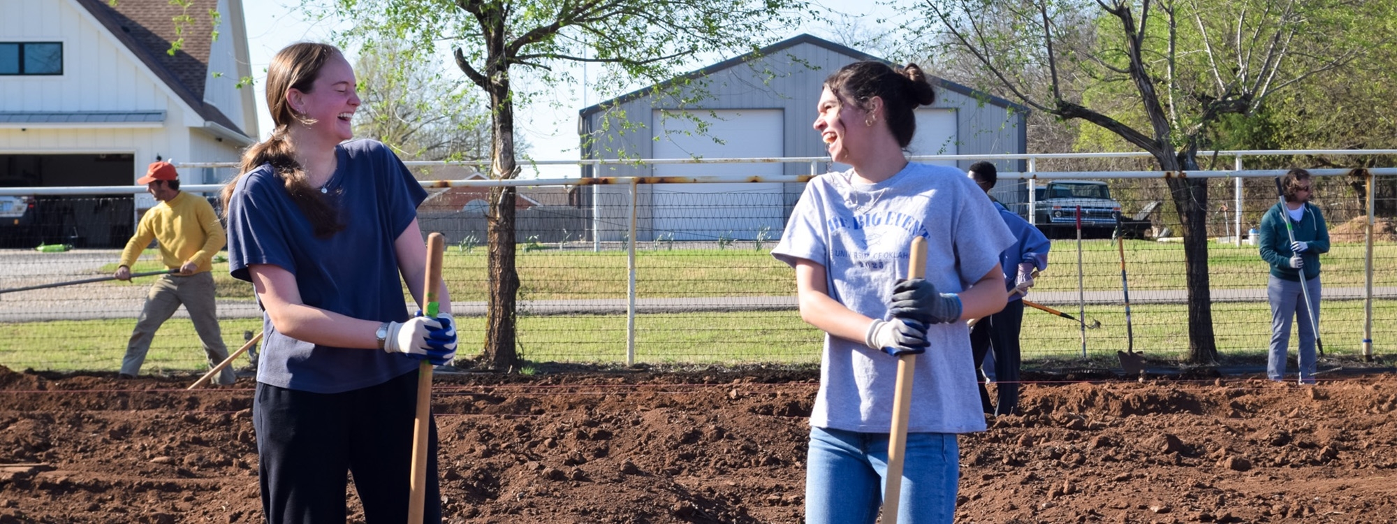Students actively volunteering at a Big Event location.