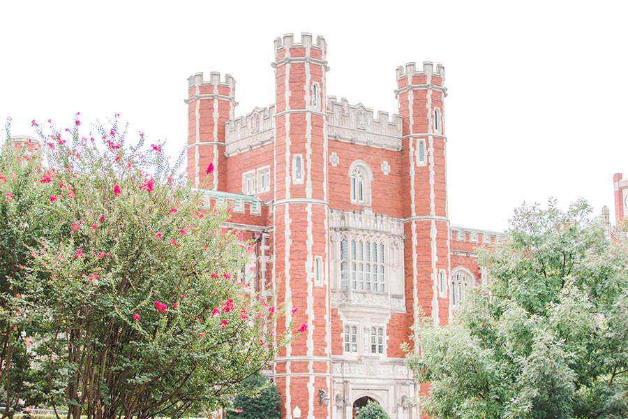 Bizzell library with flowering trees on a bright sunny day.