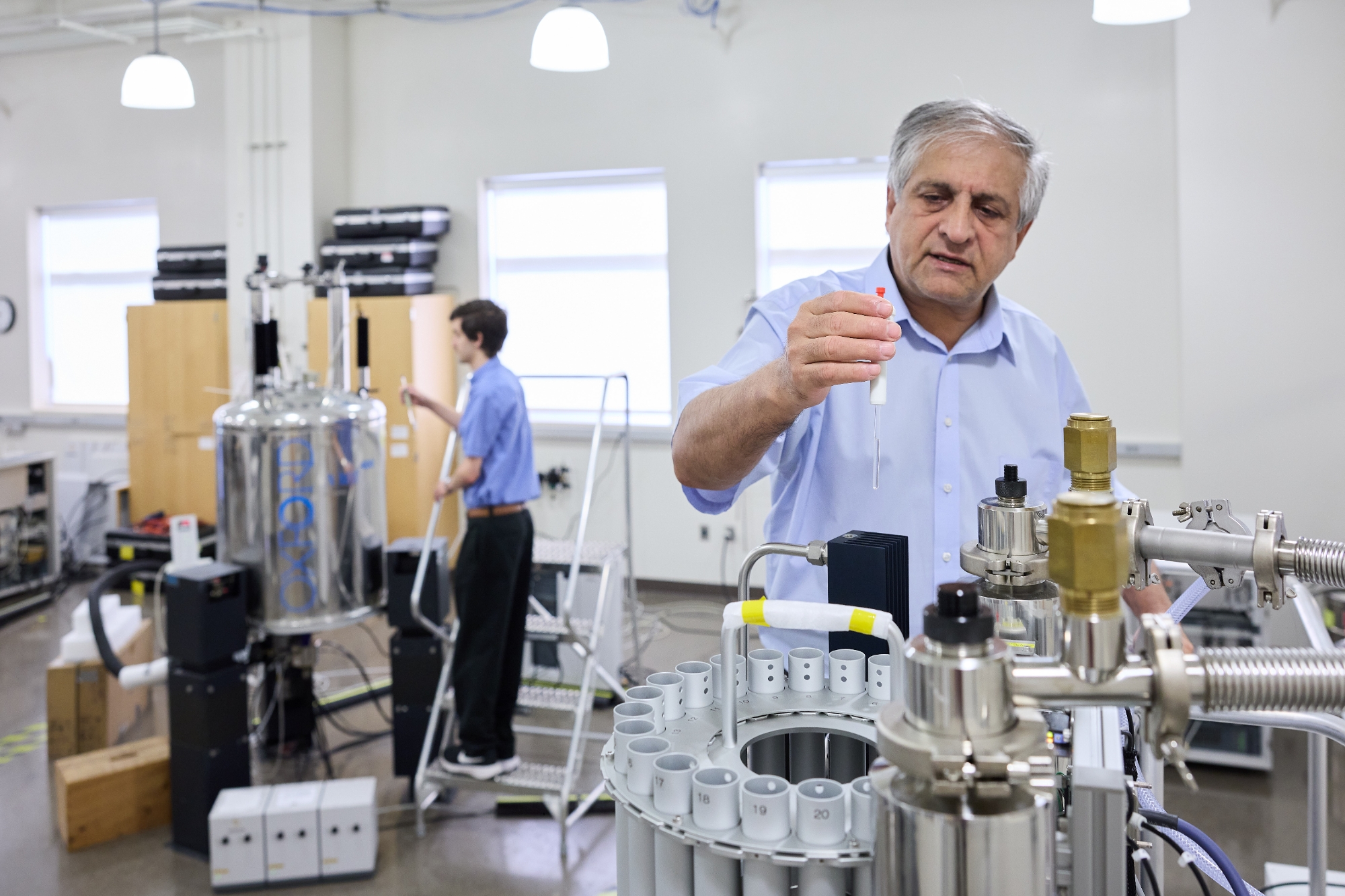 Researchers working in a laboratory with various equipment.
