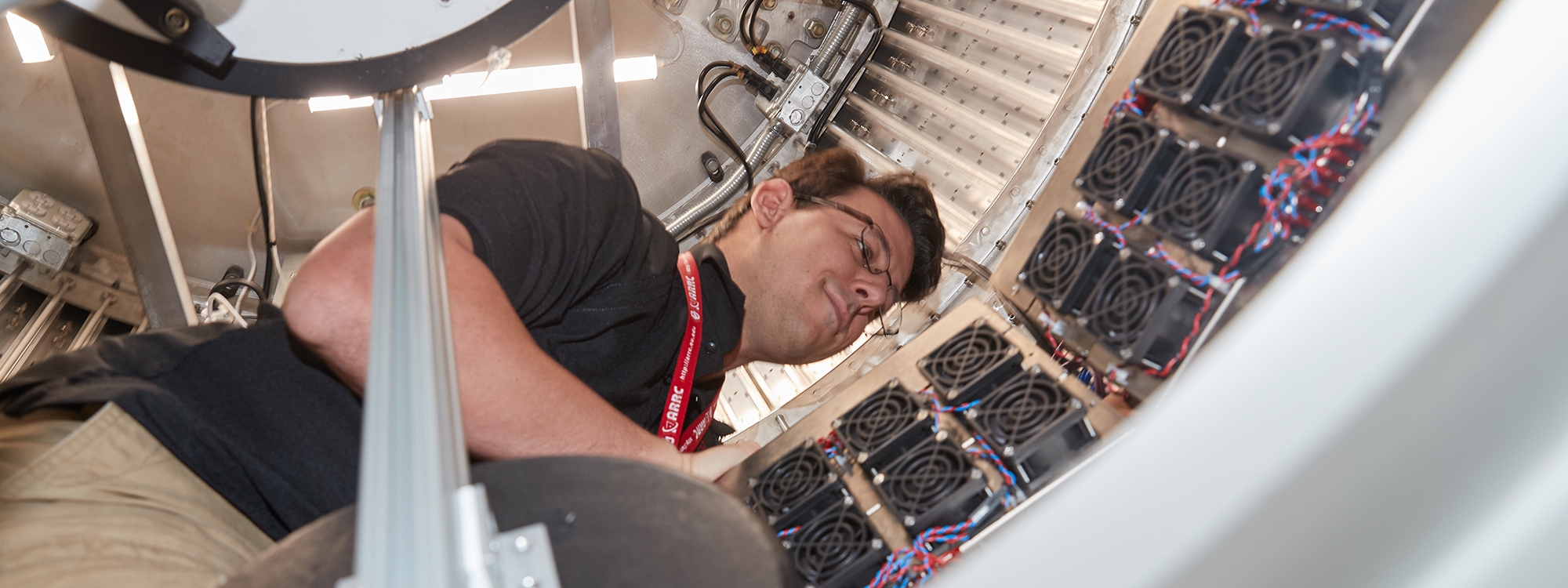A scientist inside of a radar dish.