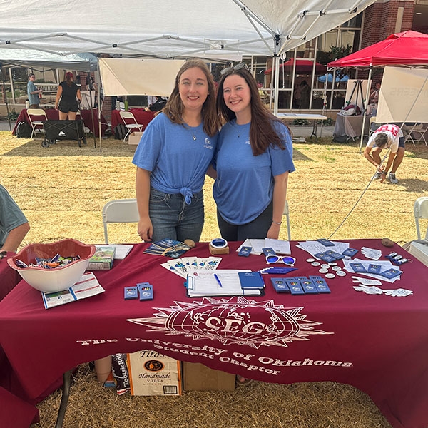 Two students at a tabling event.