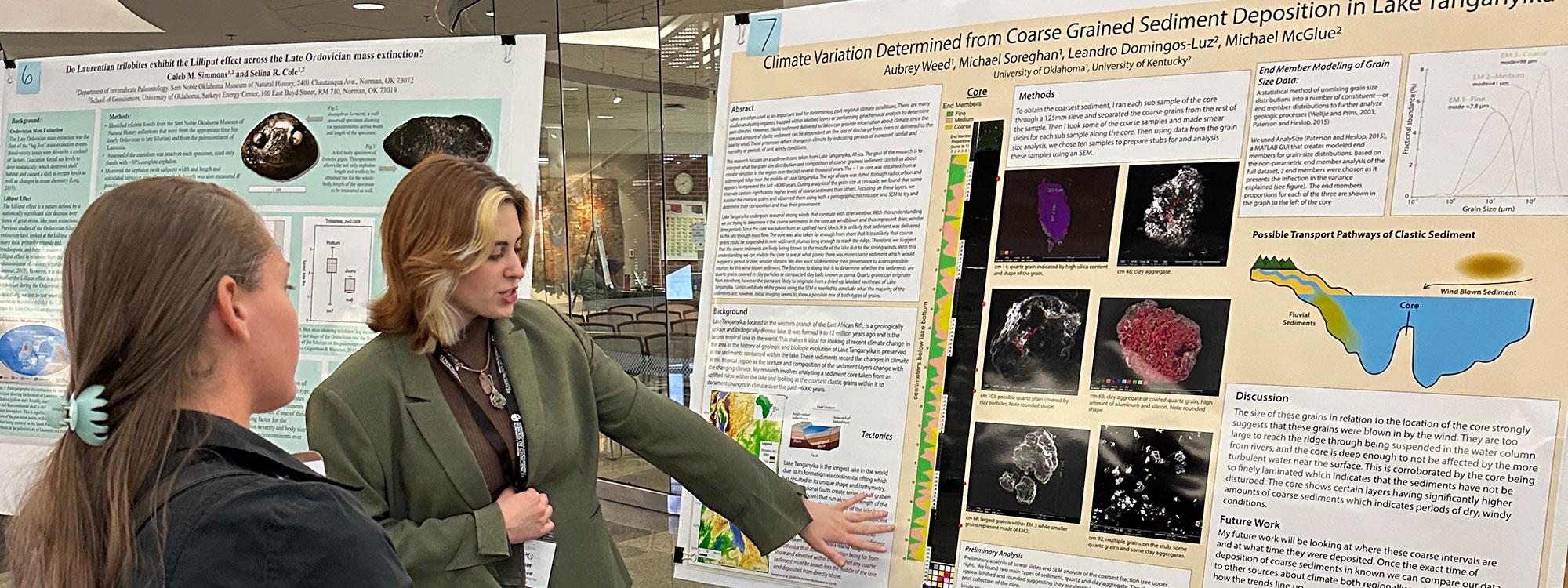 A student presenting a research poster to a judge.