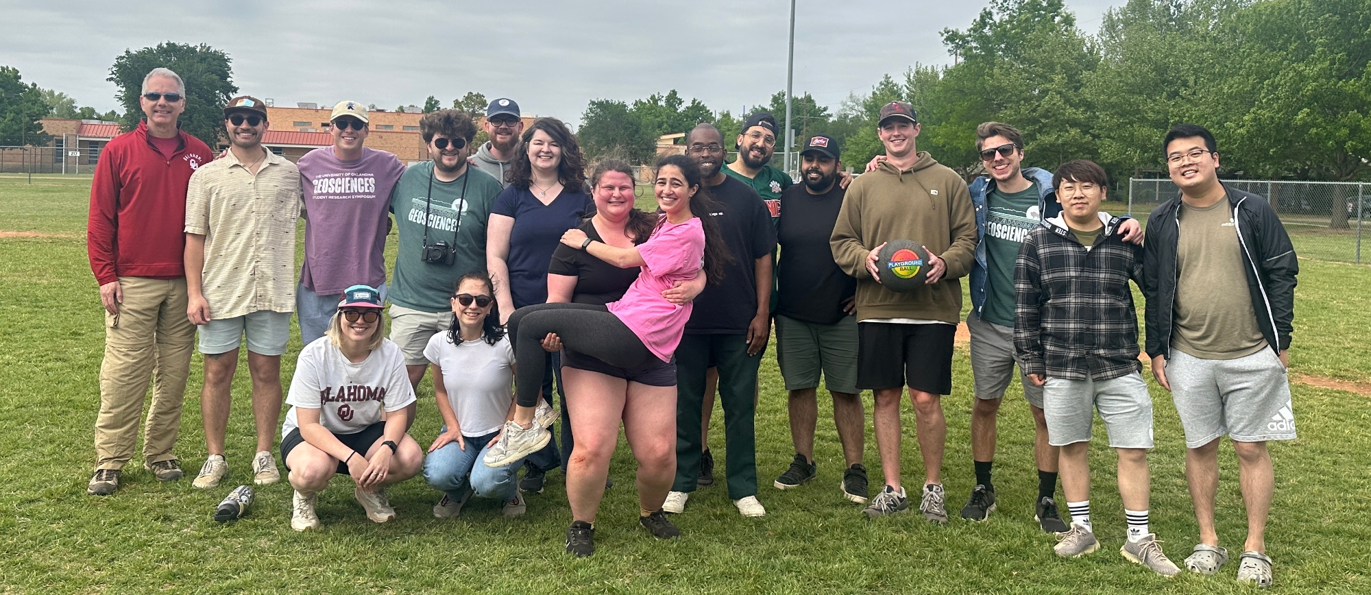 A group of students posing after playing kickball.