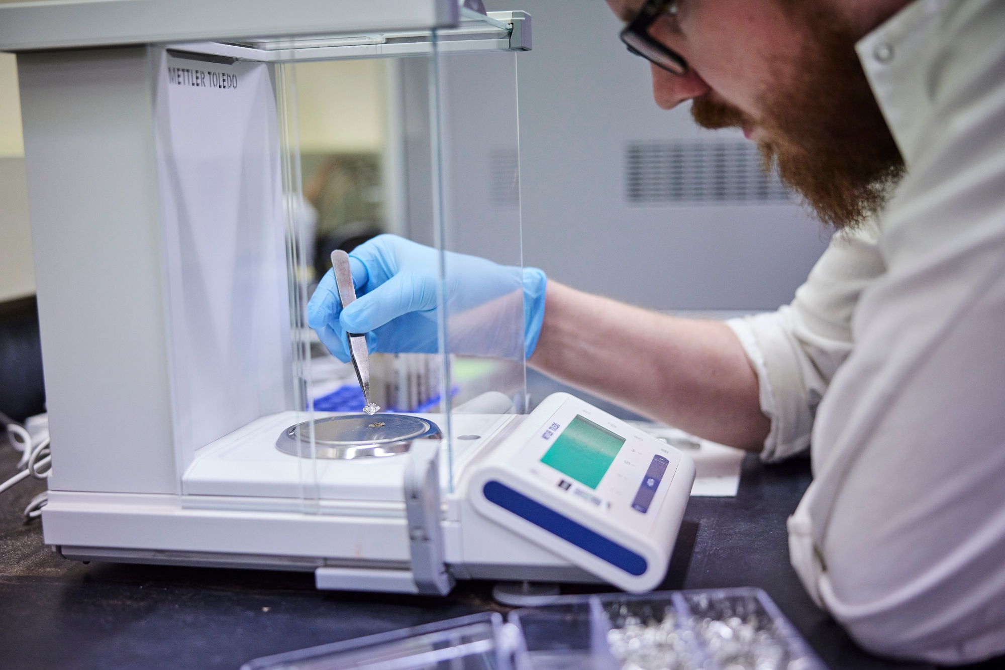A professor and student working on a computer for research.