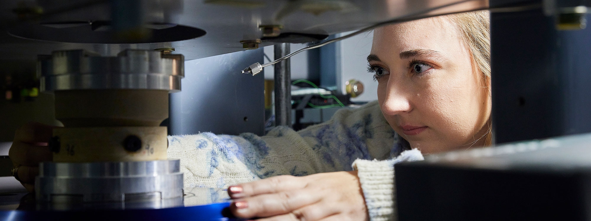 A student looking at lab equipment.