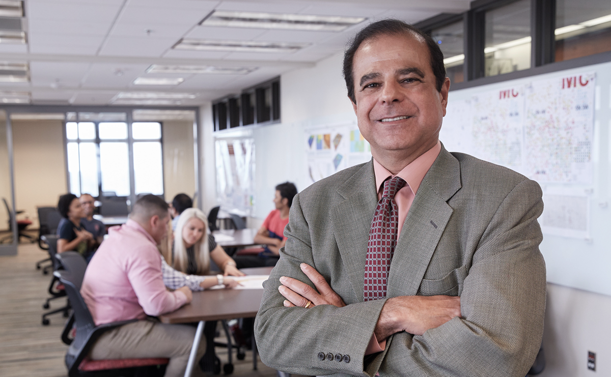 Ronnie Irani standing in front of Mewbourne students.