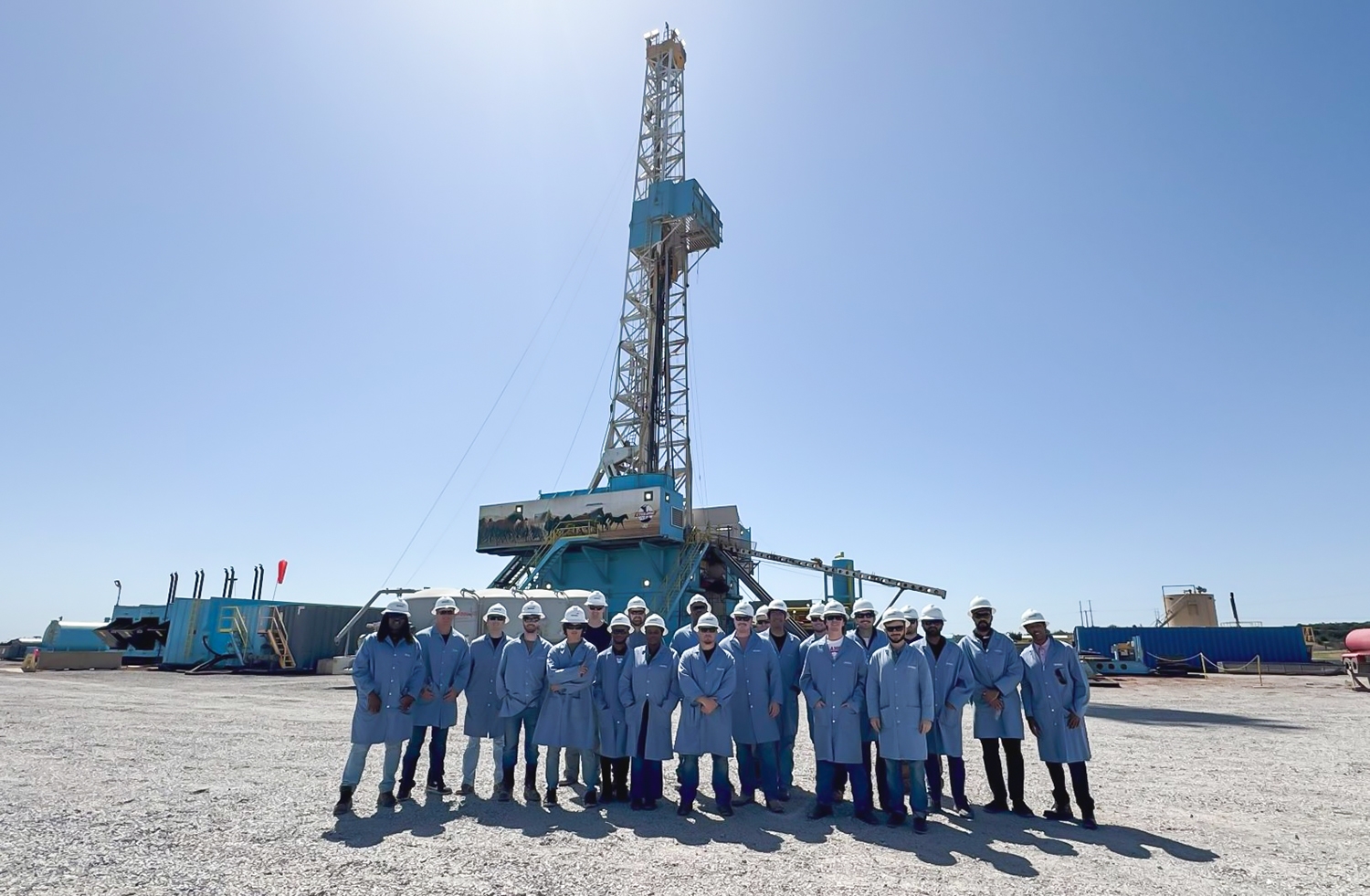 Students in front of a drilling rig.