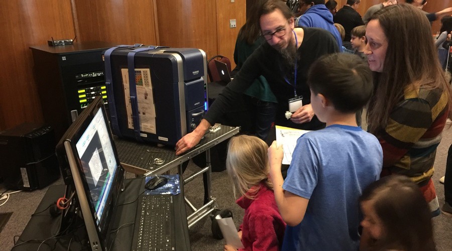 Dr. Preston Larson helping kids image their sample using the benchtop scanning electron microscope