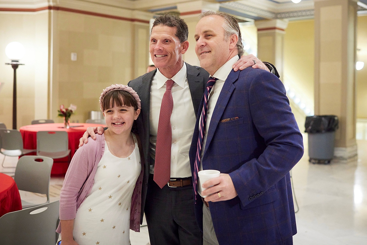 OU Head Football Coach Brent Venables (center) visits with Oklahoma Senate Pro Tempore Greg Treat and his daughter, Olivia.