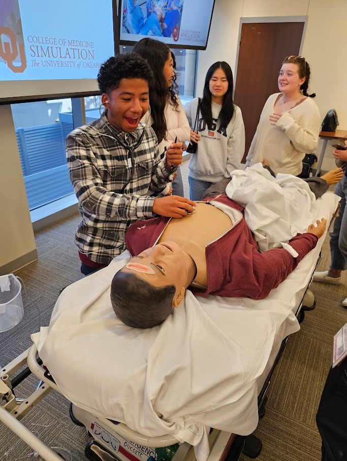 An Oklahoma high school student listening to a heartbeat during the OU College of Medicine’s simulation event.