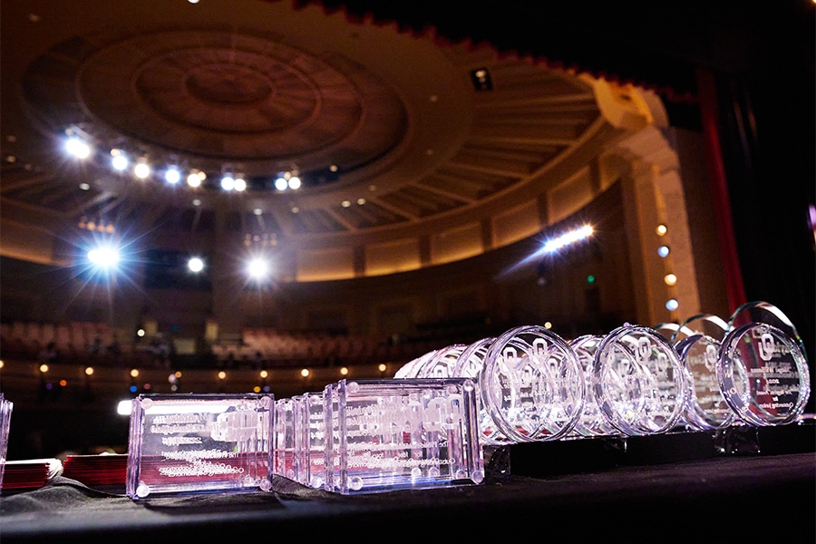 A table of the awards at the front of an auditorium.