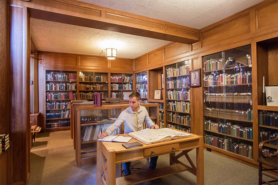 An OU student sitting in the Western History Collection.