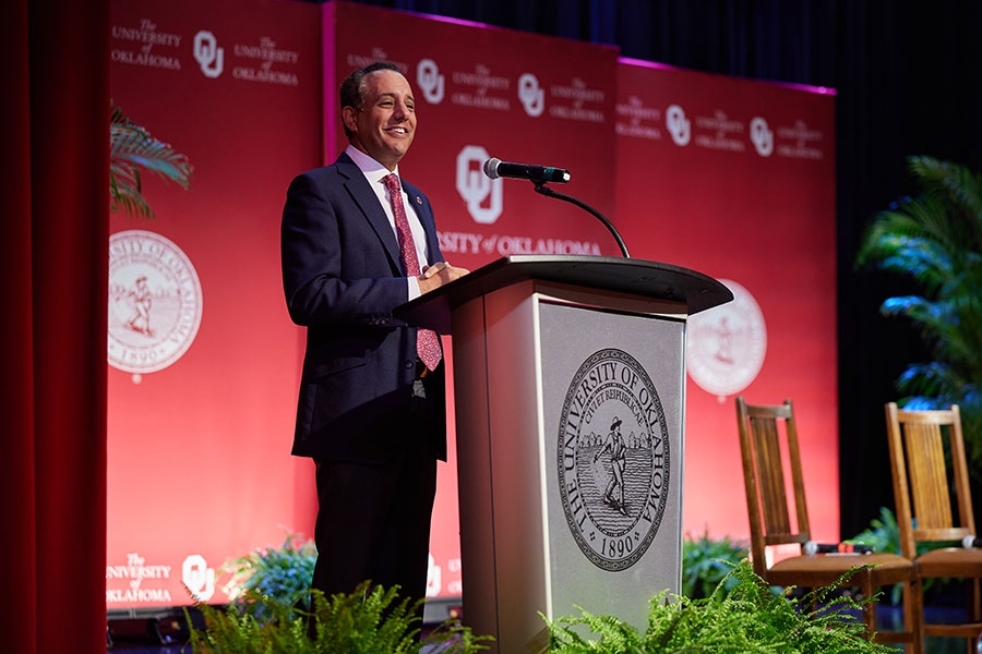 President Harroz stands at a podium giving his State of the University Address.