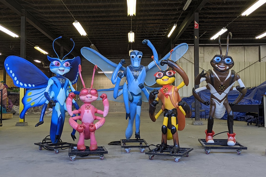 Five animatronic bugs in a warehouse.