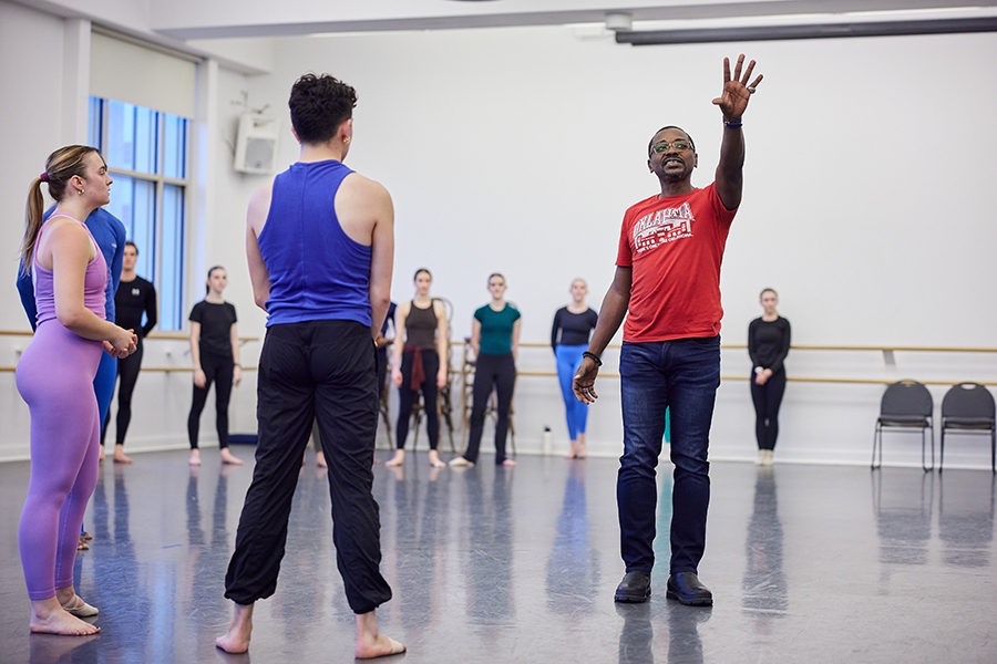 A group of people practicing in a dance studio.