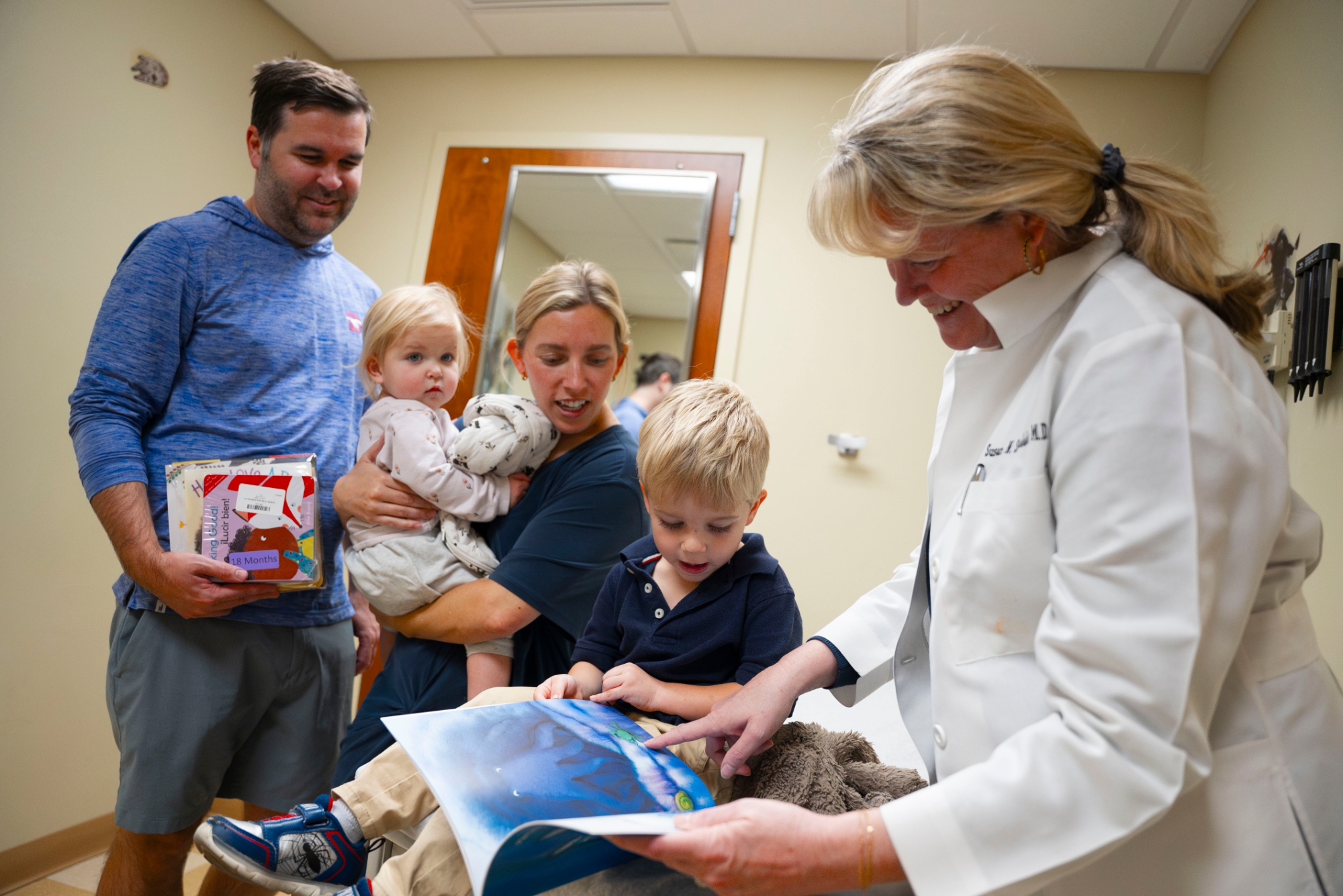  A family enjoys their new books at their child’s check-up appointment.
