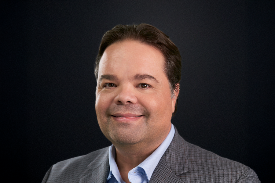 A headshot of Carlos Bustamante.