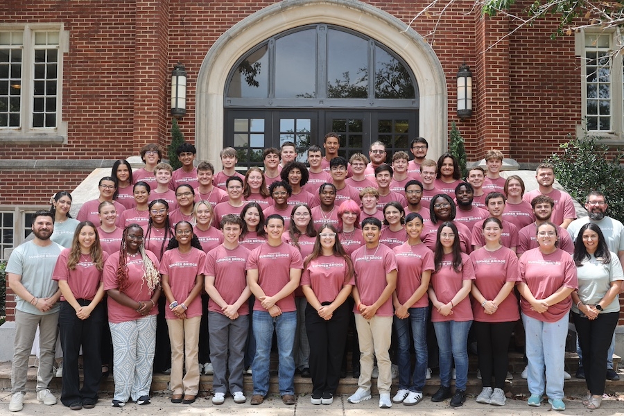 Group of engineeering students in front of college building.