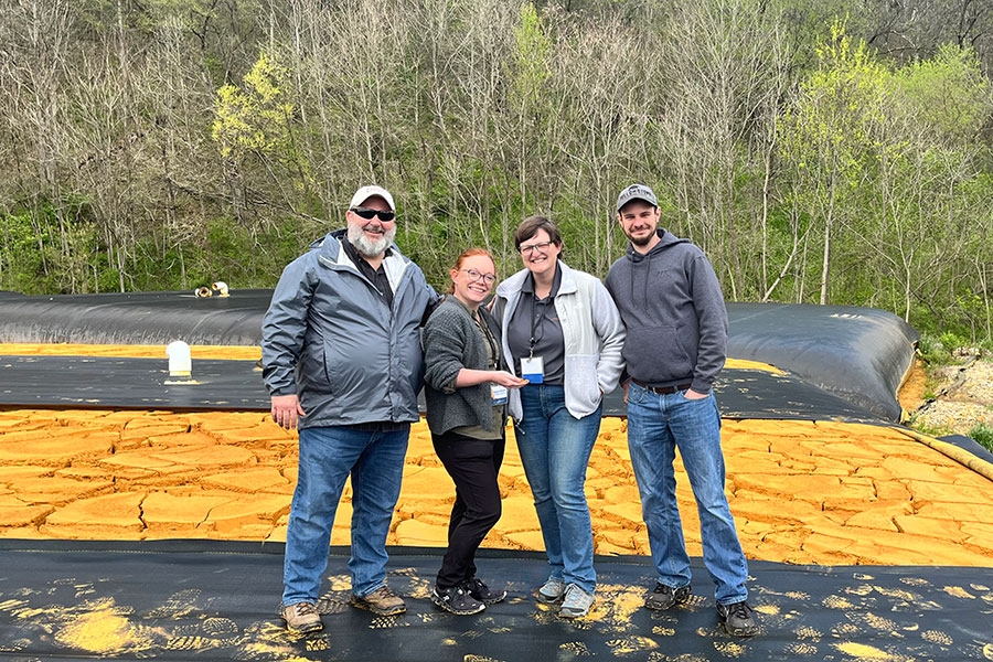 CREW researchers Robert Nairn, M’Kenzie Dorman, Justine McCann and Nick Shepherd (L to R) stand in front of recovered iron oxide mine drainage residuals at the Lowber mine water passive treatment system in Westmoreland County, Pennsylvania.