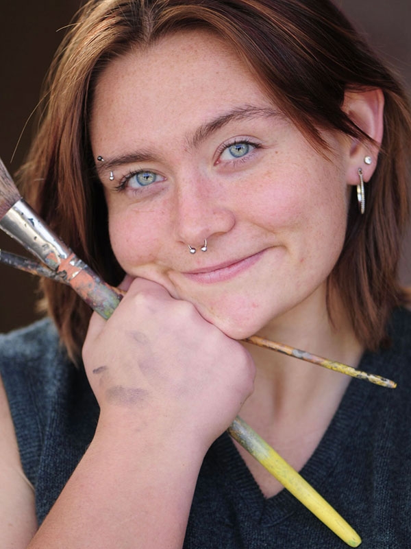 Goldie Snow holding paint brushes