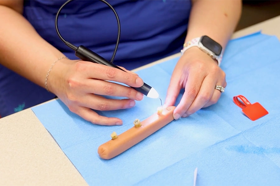 A dental student practicing laser therapy.