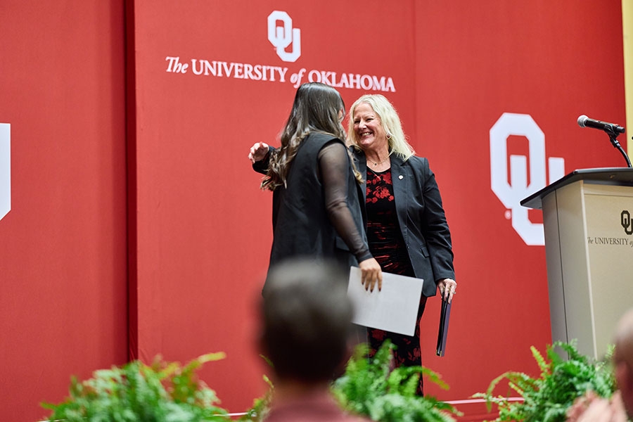 Two people embracing on stage. 