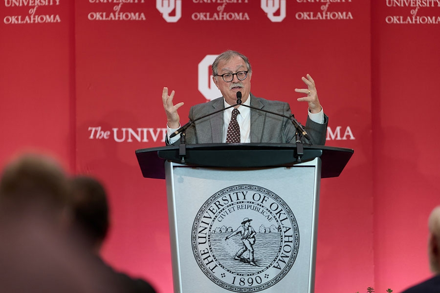 Wilfred McClay speaking to crowd while behind lectern at University of Oklahoma event.