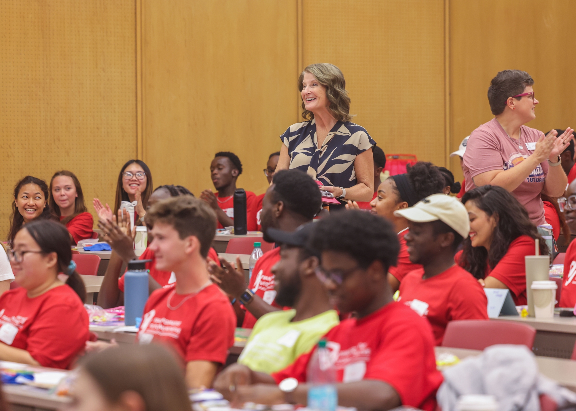 A teacher standing amongst students.