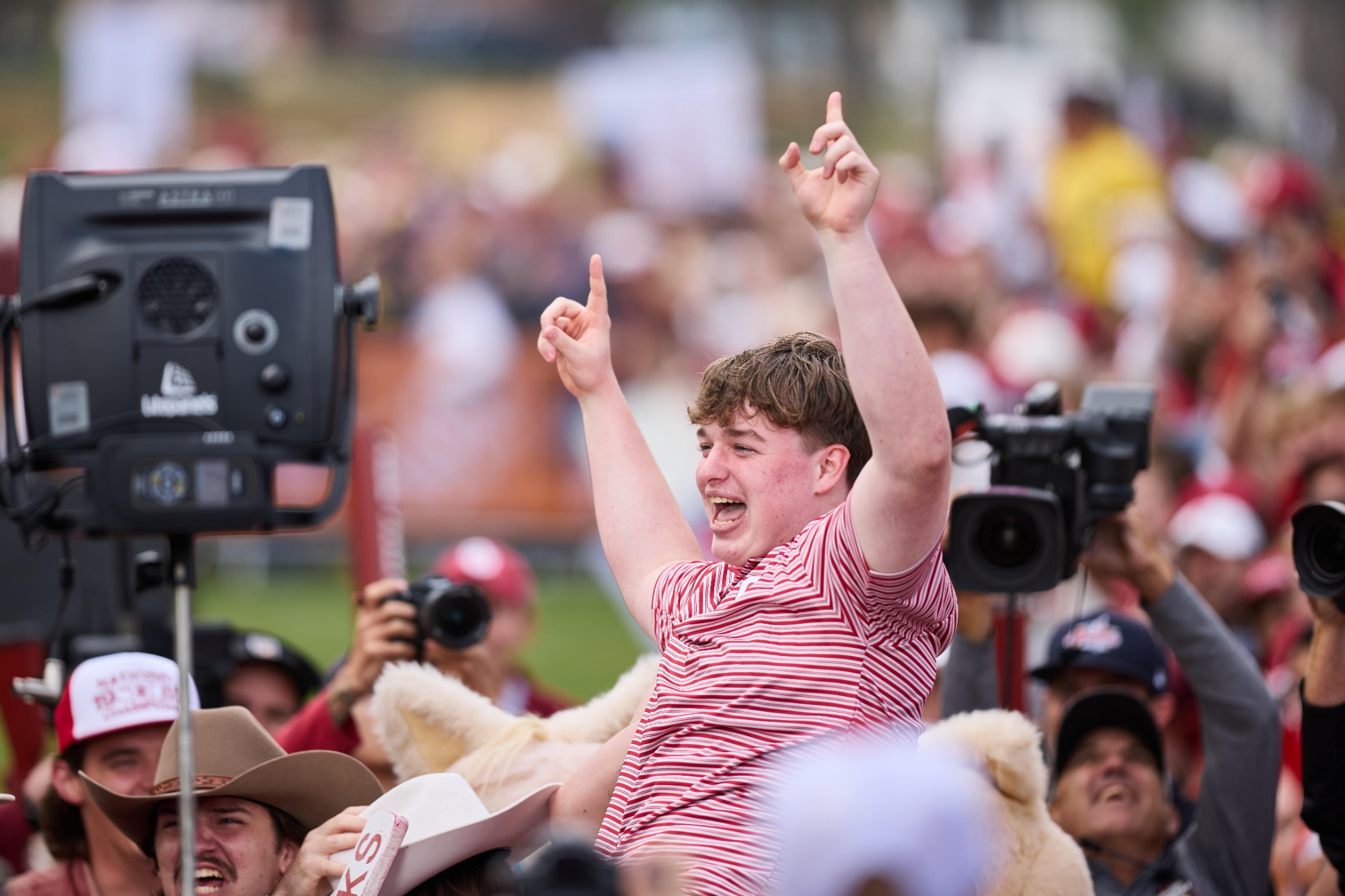 Jack with his hands raised in the air in celebration.