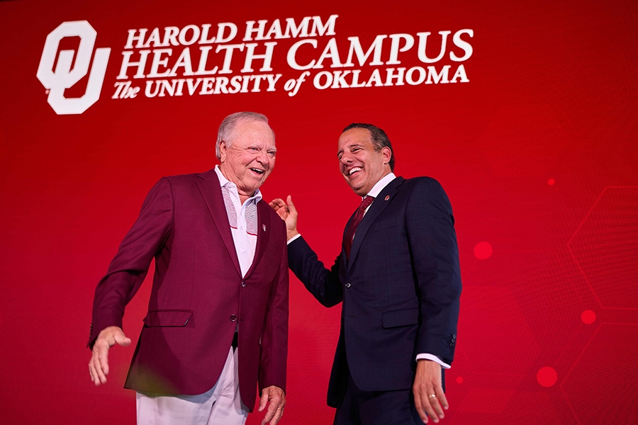 Harold Hamm and University of Oklahoma President Joseph Harroz, Jr. on a stage.