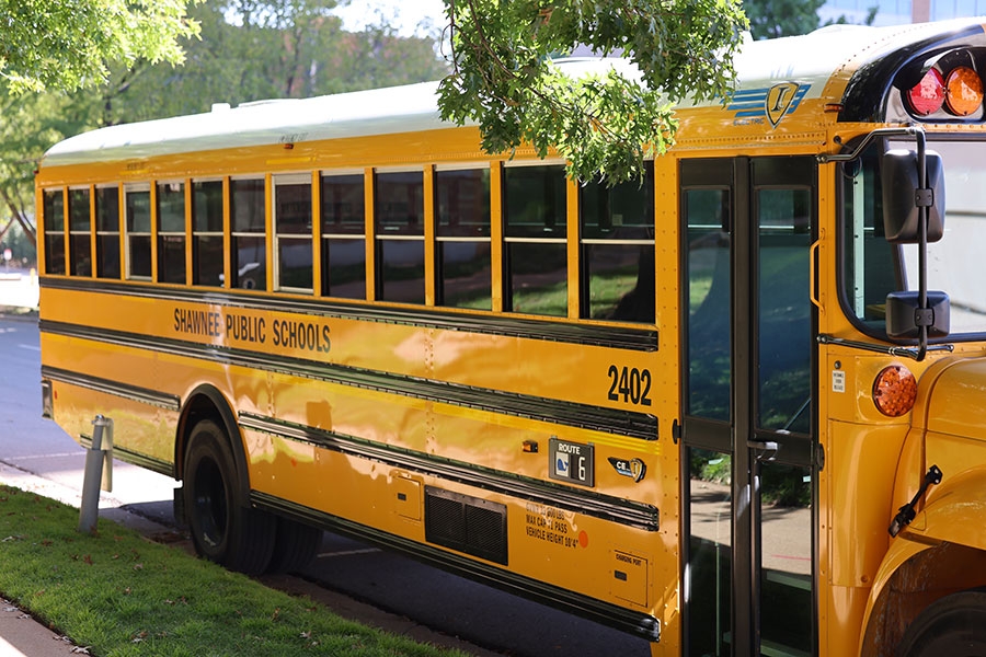 Shawnee Public Schools electric bus parked on curb