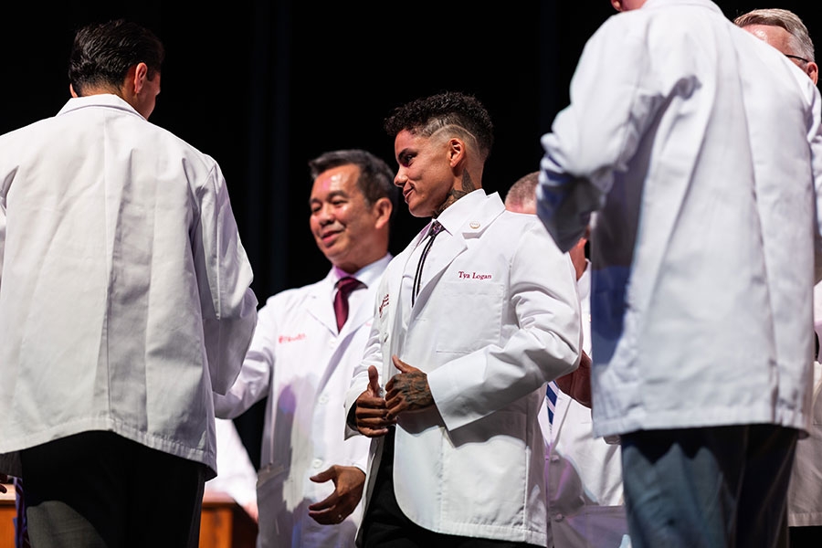 A group of people in white coats. 