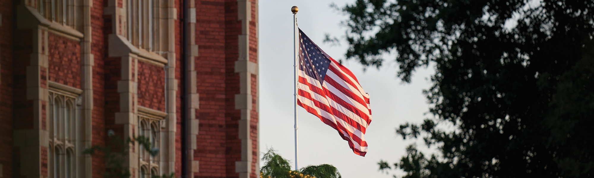 United States flag flying over University of Oklahoma campus.
