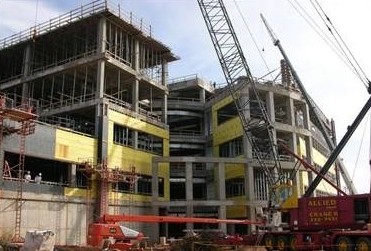 The National Weather Center under construction, with cranes in the background.
